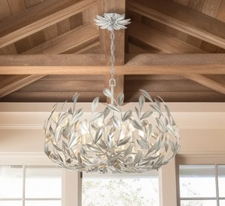 White leaf-form chandelier hanging from a beamed ceiling, sold at Williams Electric Supply
